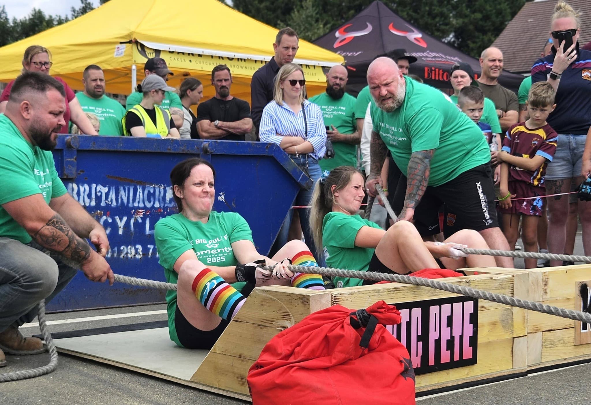 Arm-over-arm sled pull at a Big Pull for Momentum, Britaniacrest branding visible