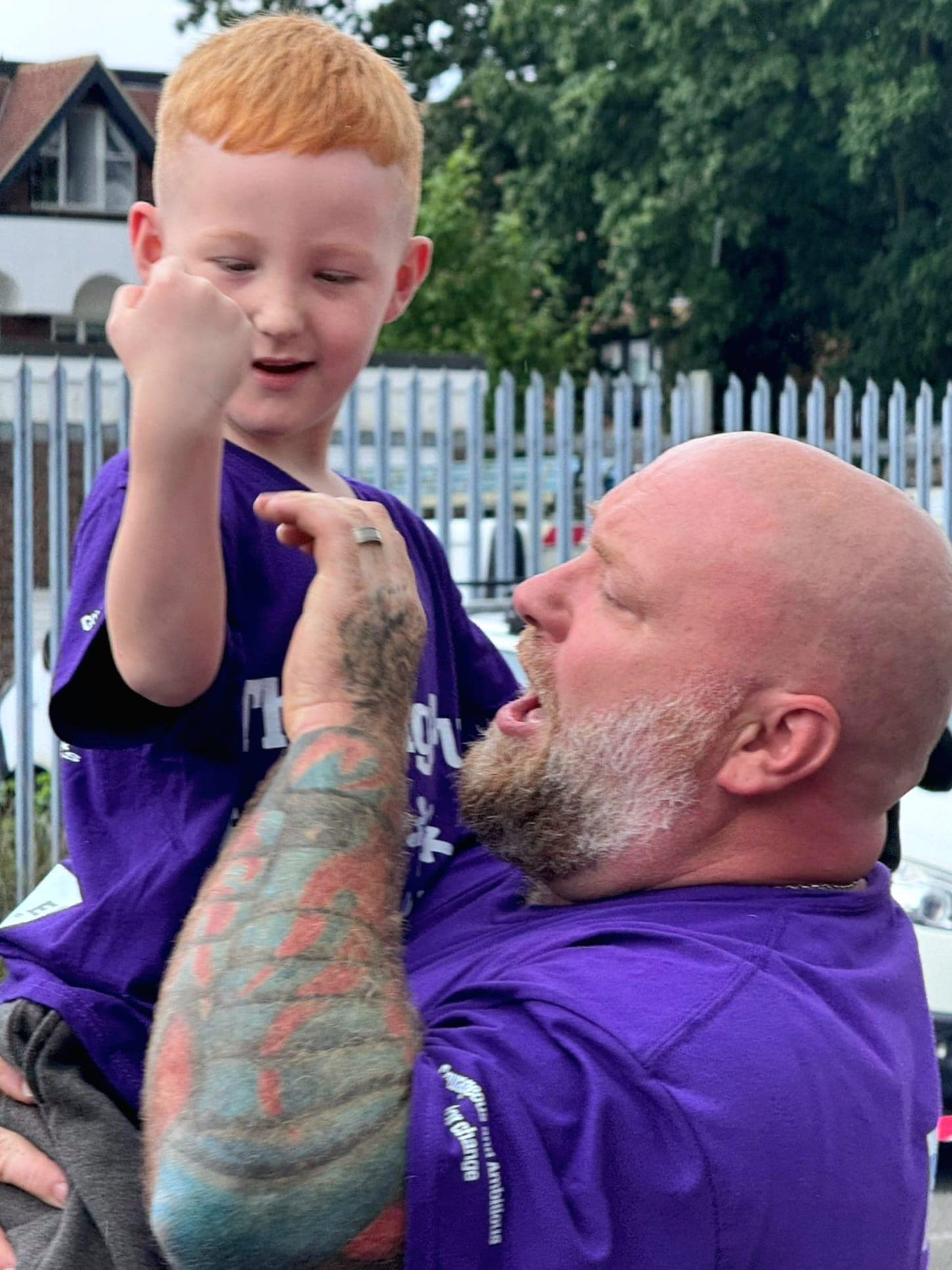 A Big Pull for St Pier's School moment — organiser holding up a young supporter